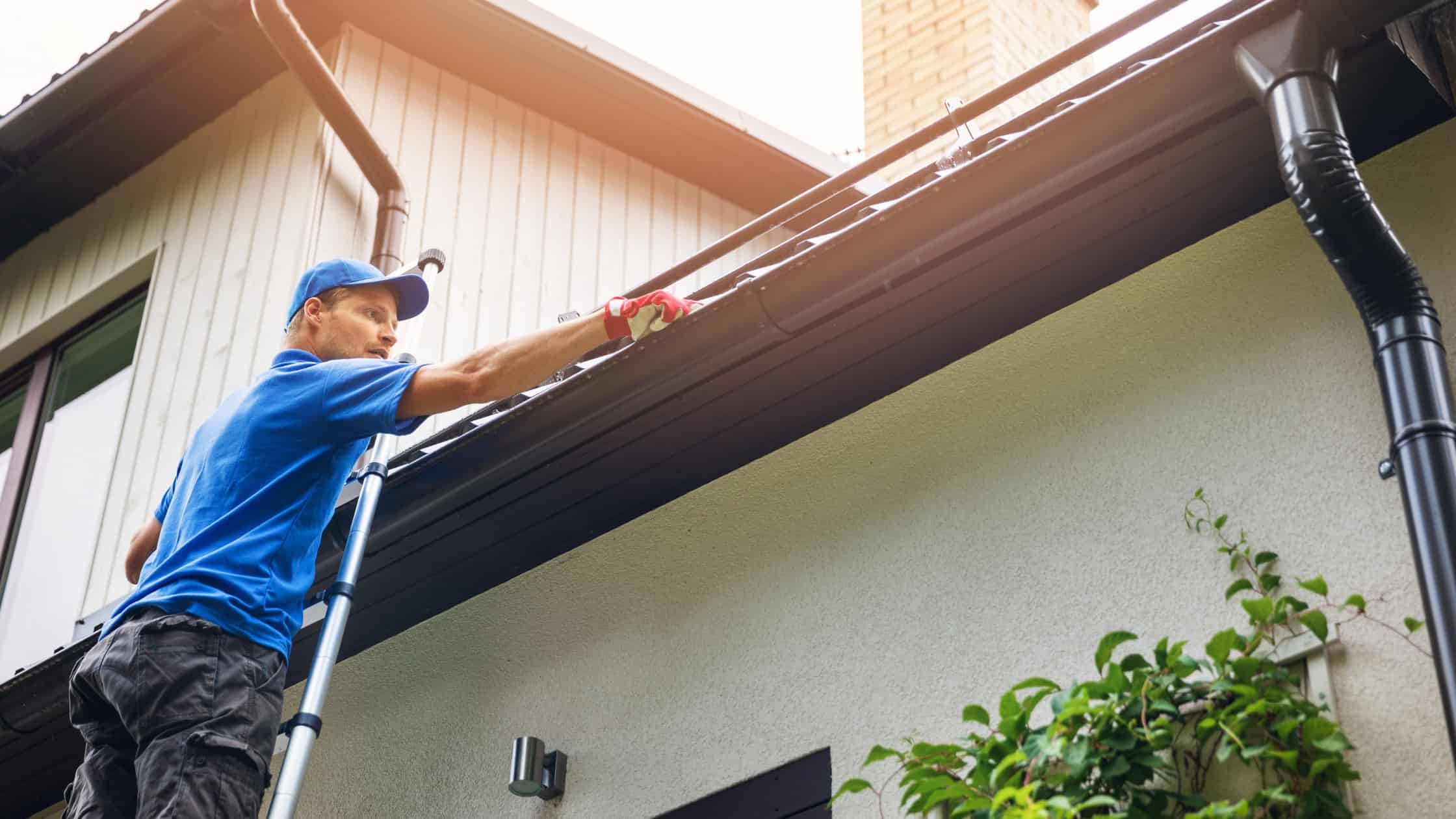 Gutter cleaning at the edge of a residential roof