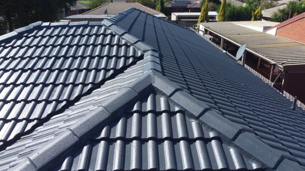 Restored dark tiled roof with ridge capping detail