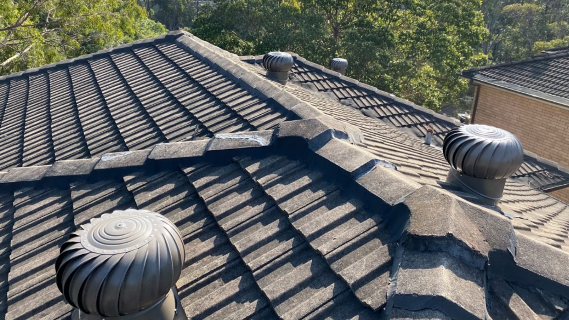 Tiled roof ventilation cowl and skylight on a residential roof