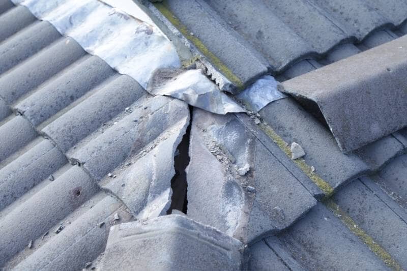 Damaged roof valley and flashing detail on a tiled Sydney roof