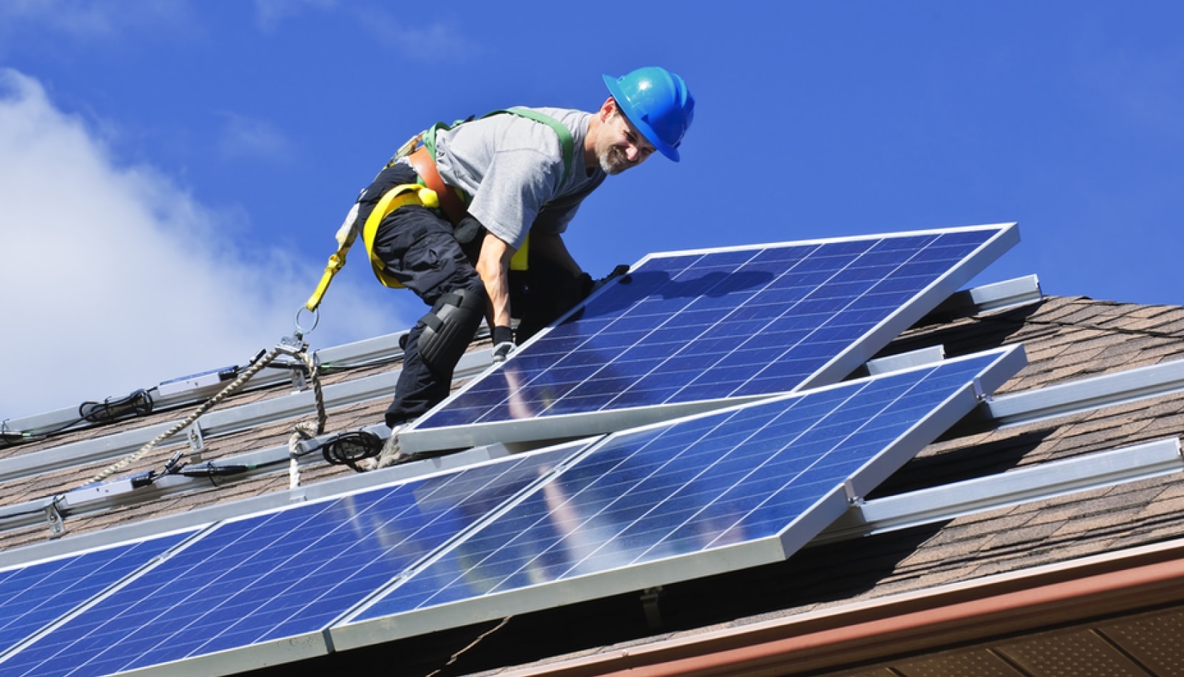 Solar panels being installed on a residential roof