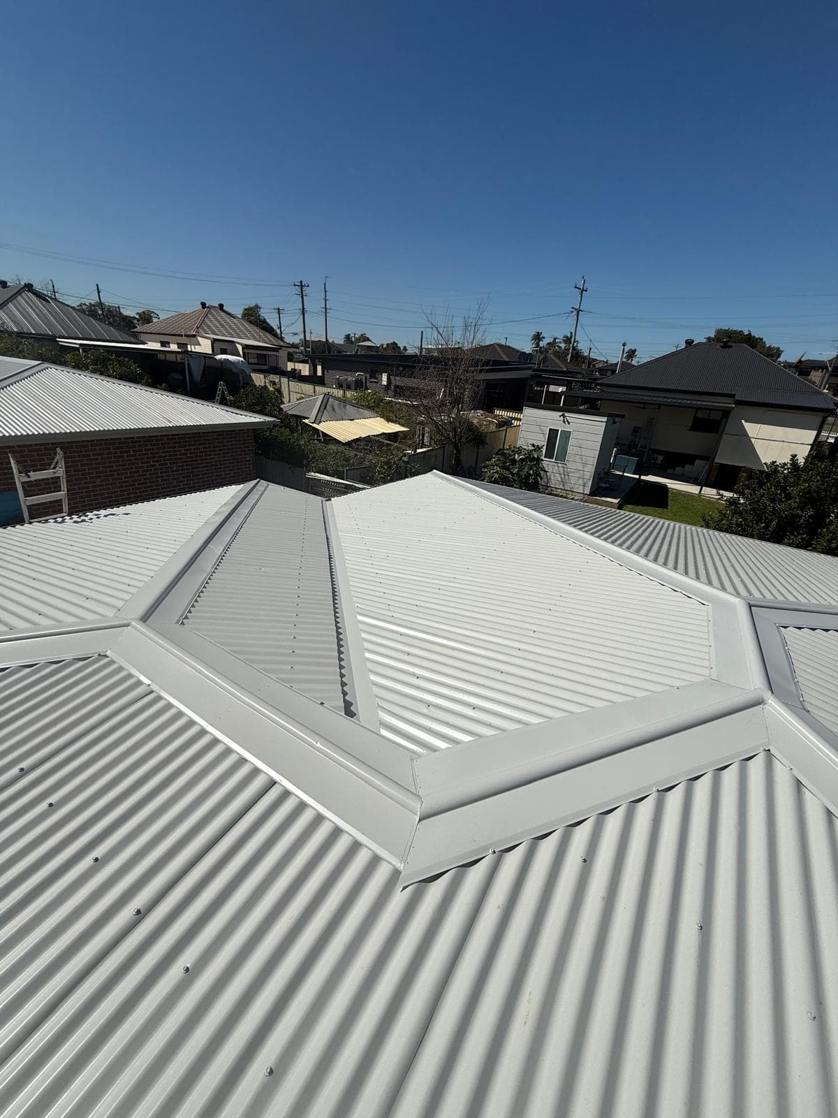 Light metal hipped roof with clean ridge lines