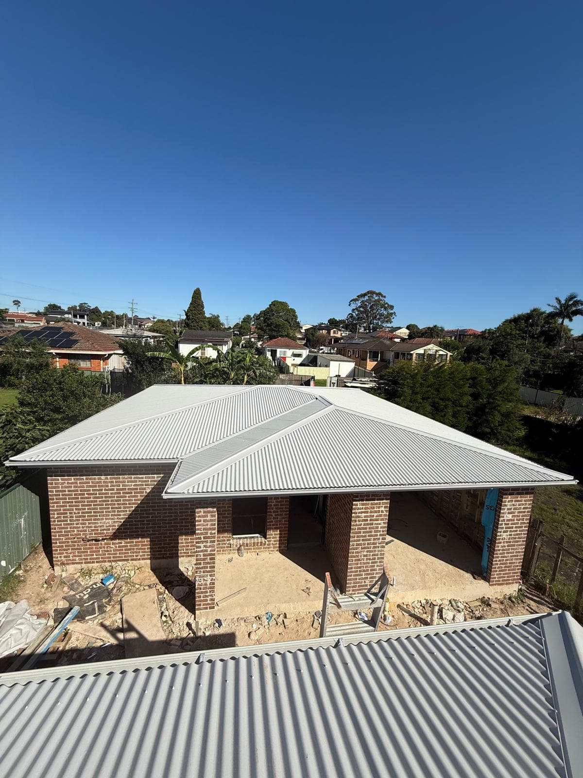 Light metal roof over a new brick residential home