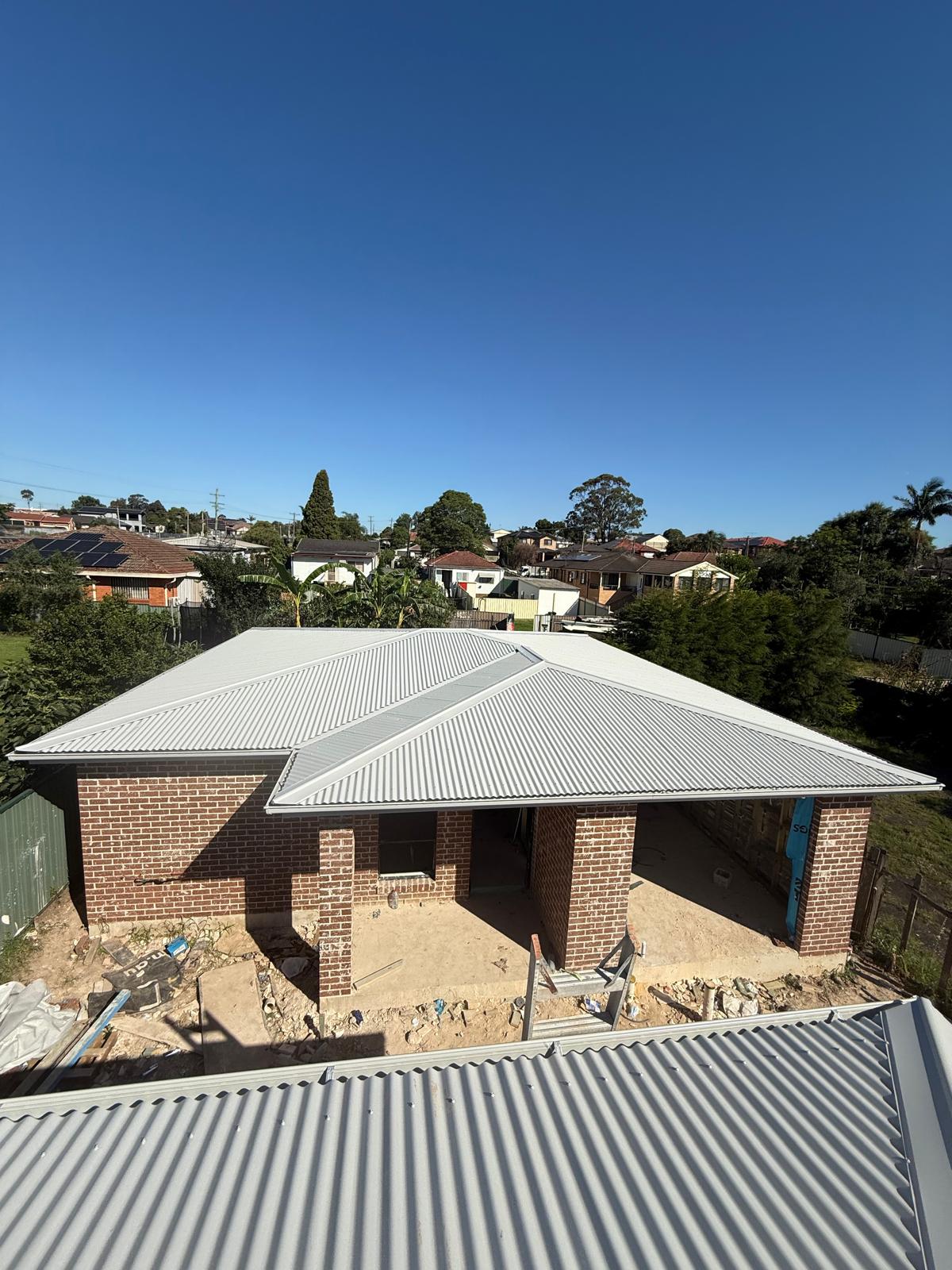 Light metal roof over a new brick residential home