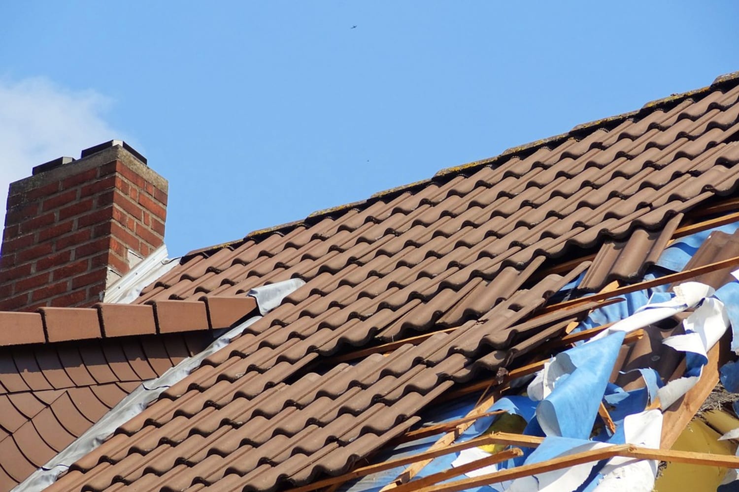 Storm-damaged tiled roof requiring urgent assessment