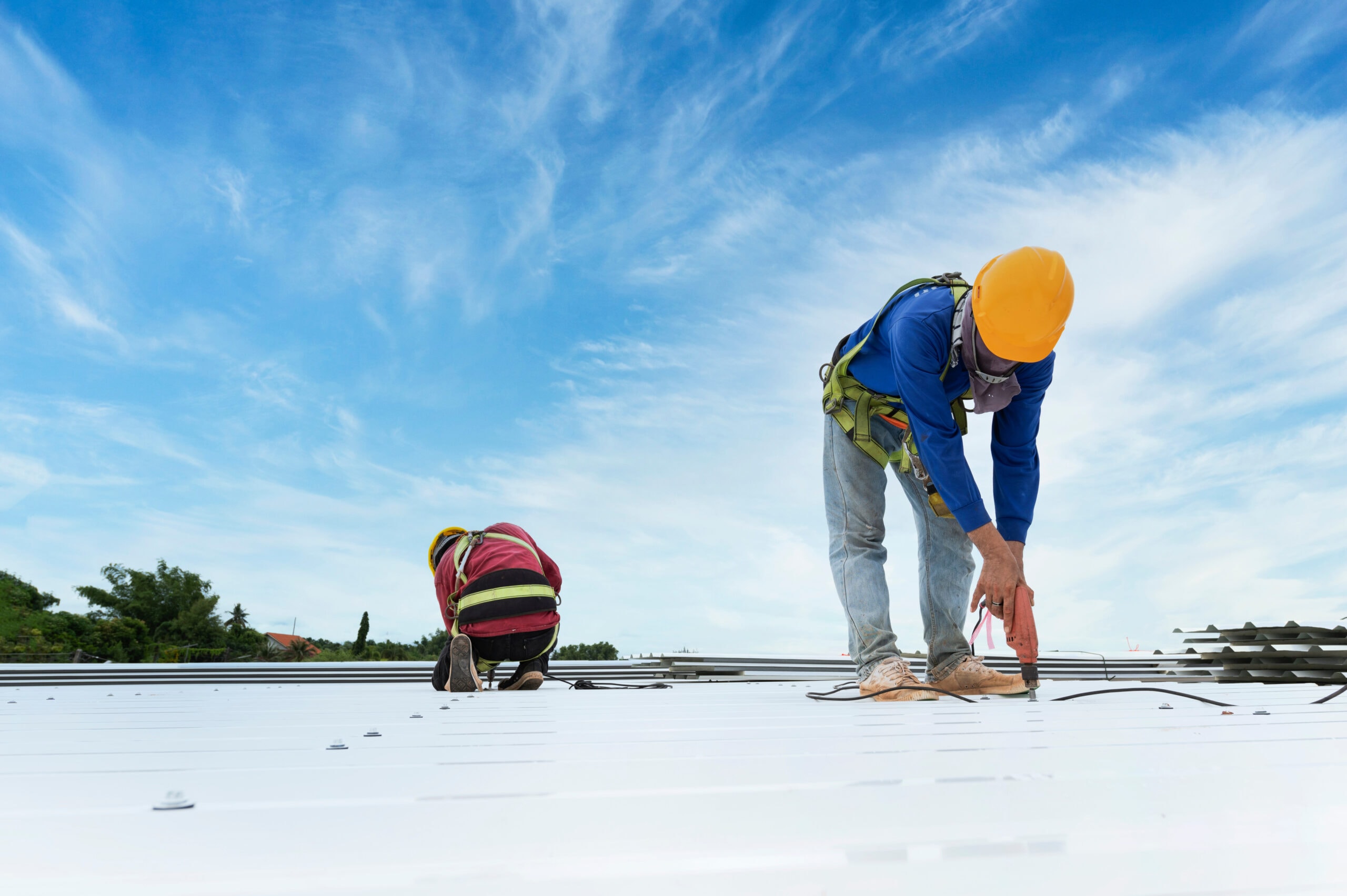 Workers inspecting a pitched tiled roof