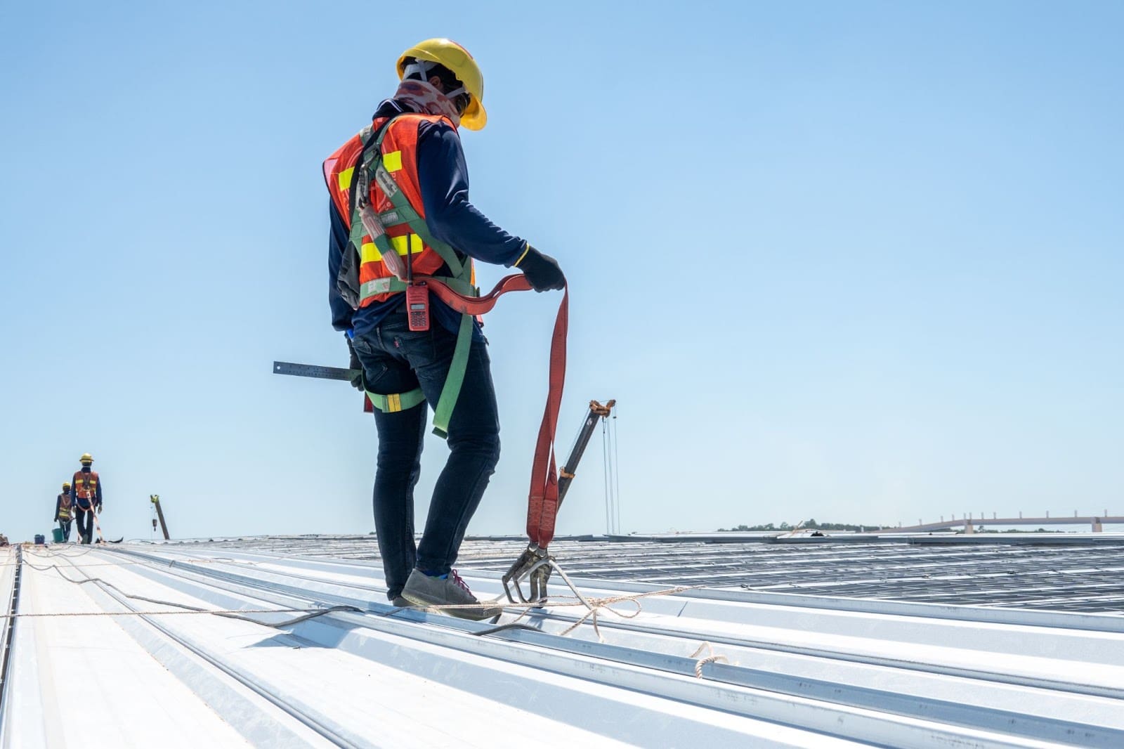Commercial roof maintenance on a large metal roof