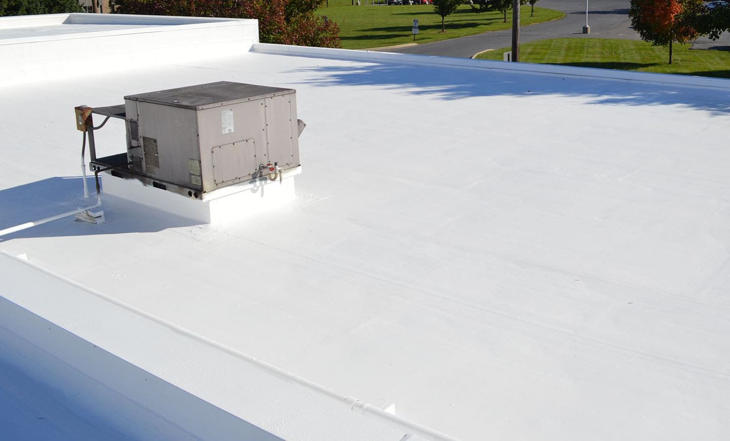 Roof coating on a light-coloured roof surface