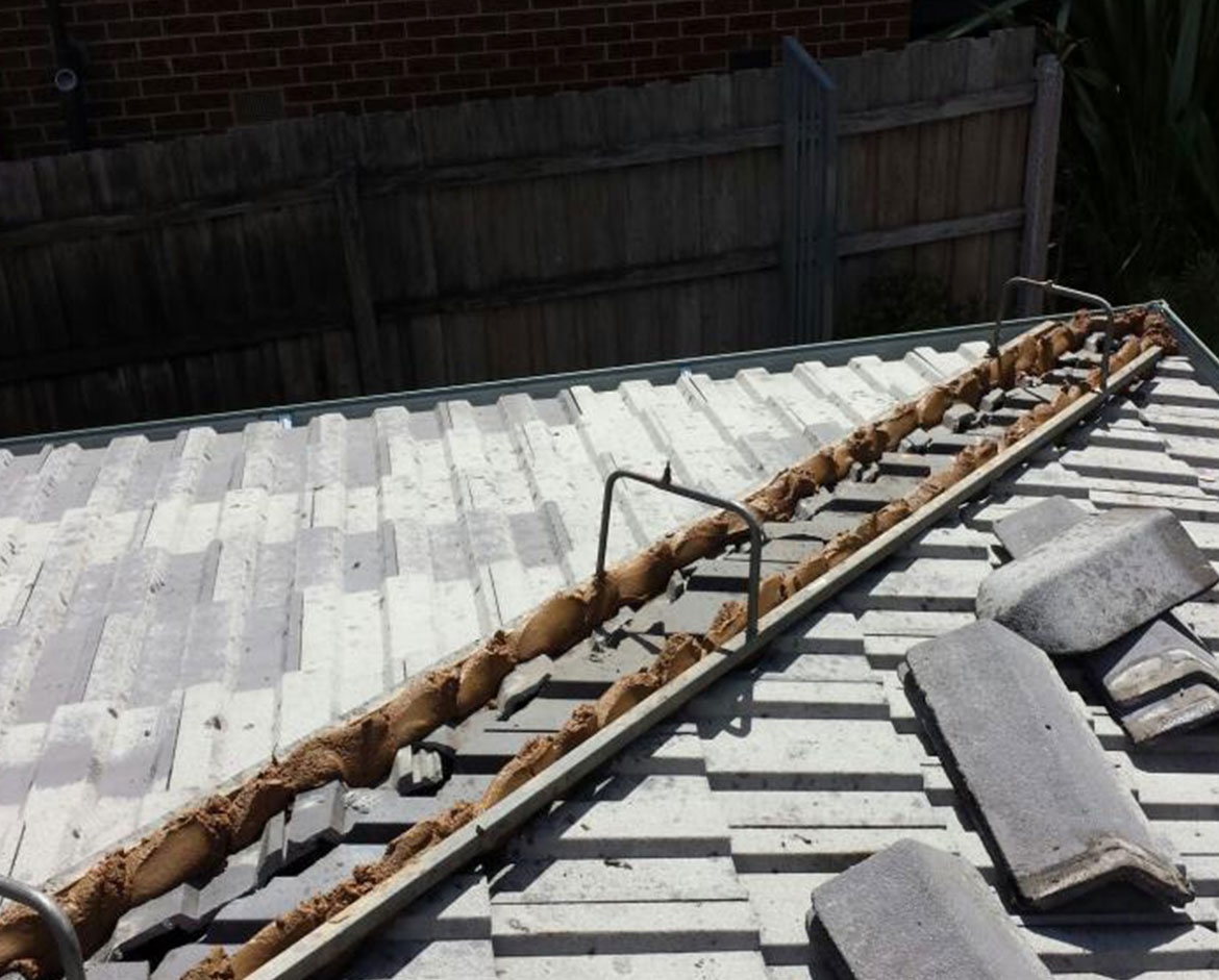 Exposed bedding beneath ridge caps on a tiled roof