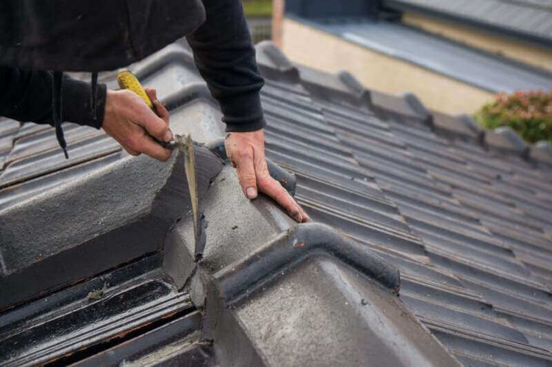 Pointing along tiled roof ridge caps