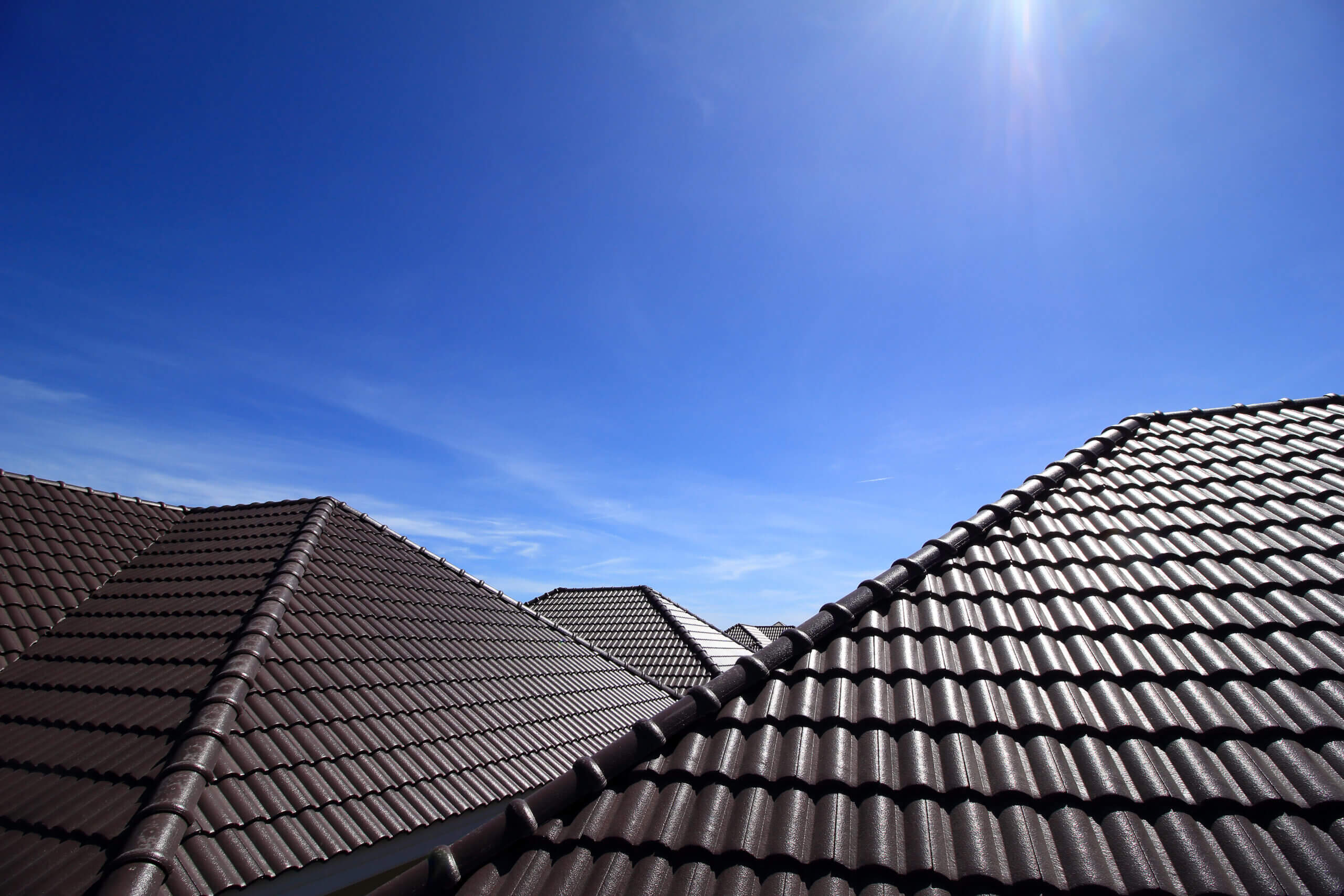 Dark tiled roof with ridge capping